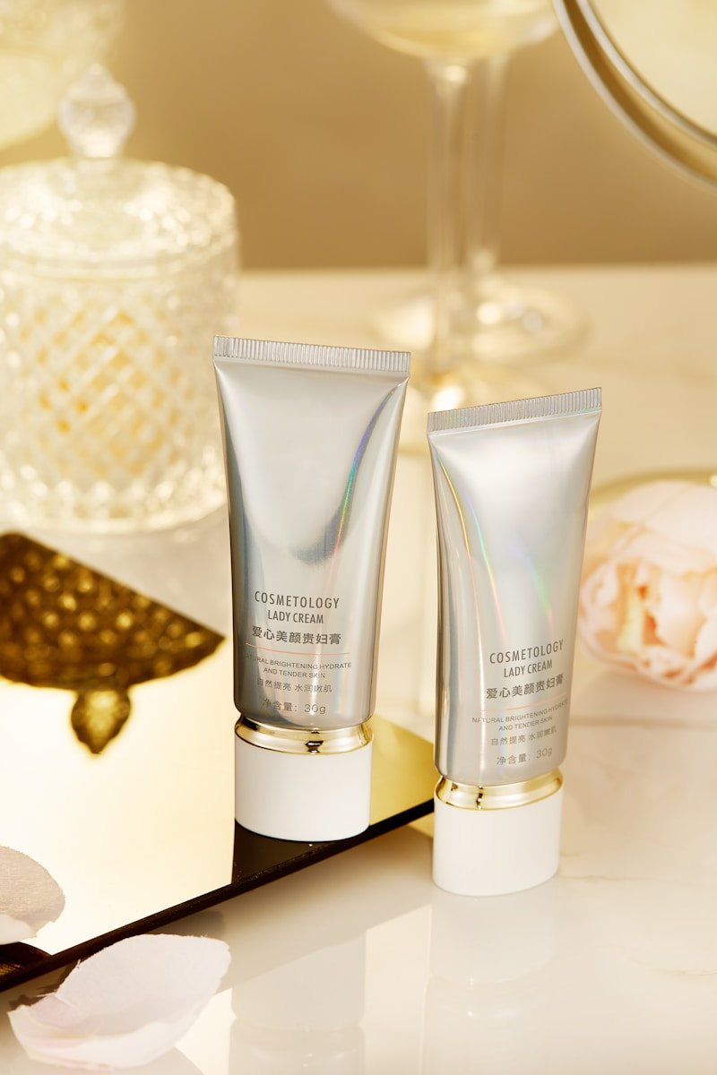 a close up of two bottles of cosmetics on a table