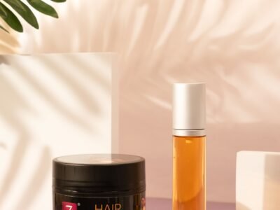 A table topped with a jar of hair mask next to a plant